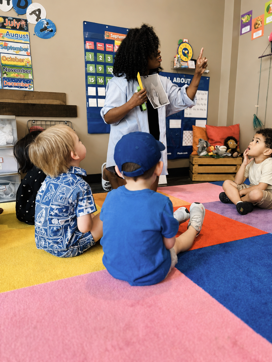 Preschool teacher leading a classroom activity with children at L&L Academy’s West Loop school.