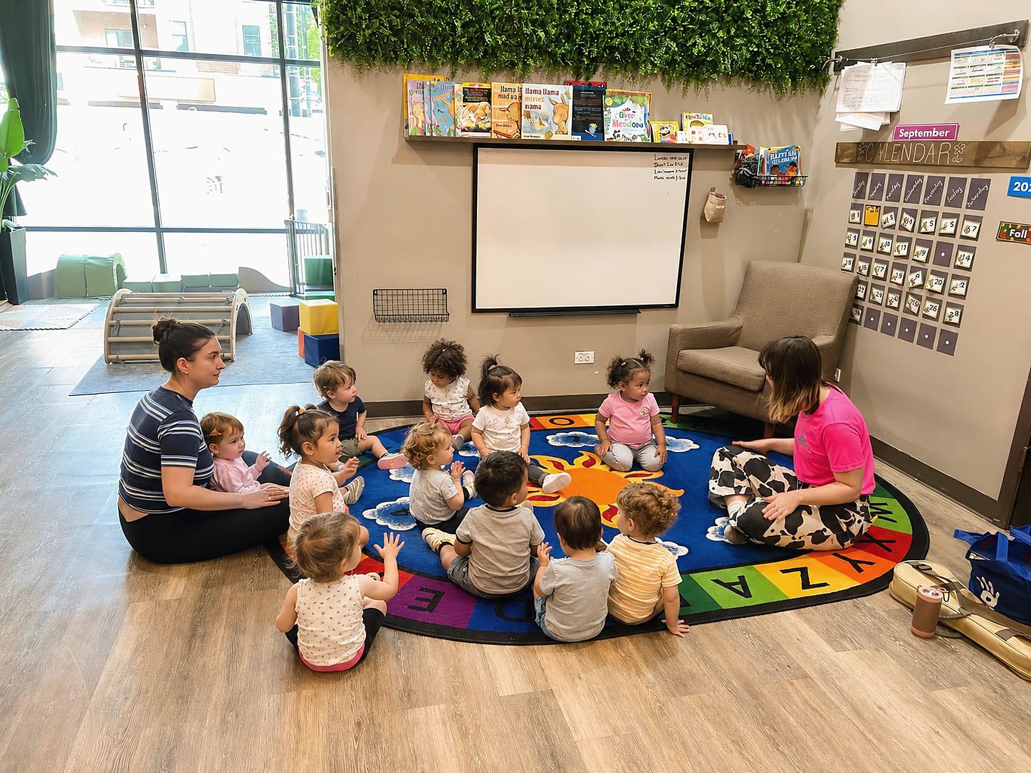 Two teachers gathered with children during group time at L&L Wicker Park.